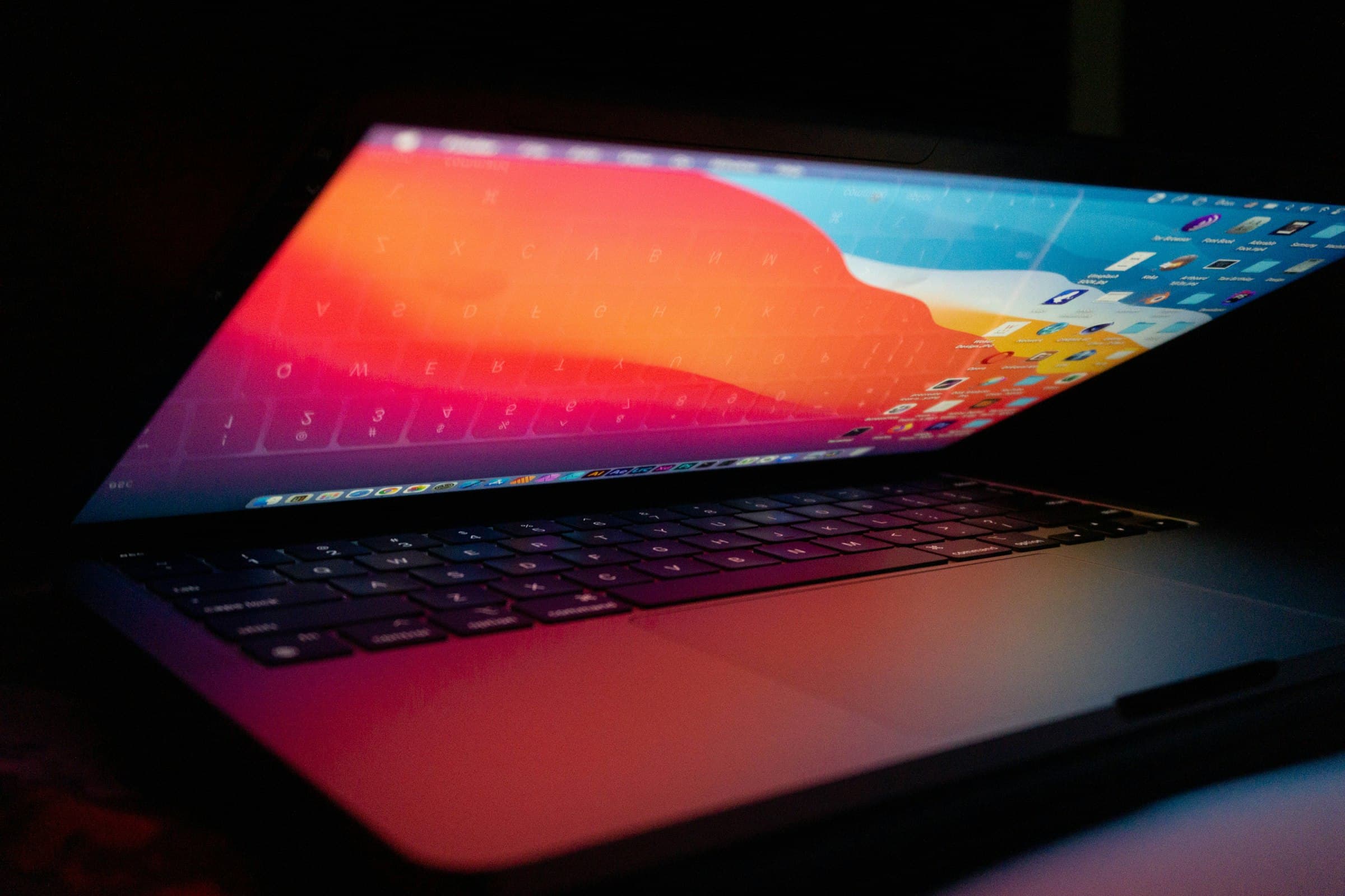 A MacBook open on a desk with its display lit